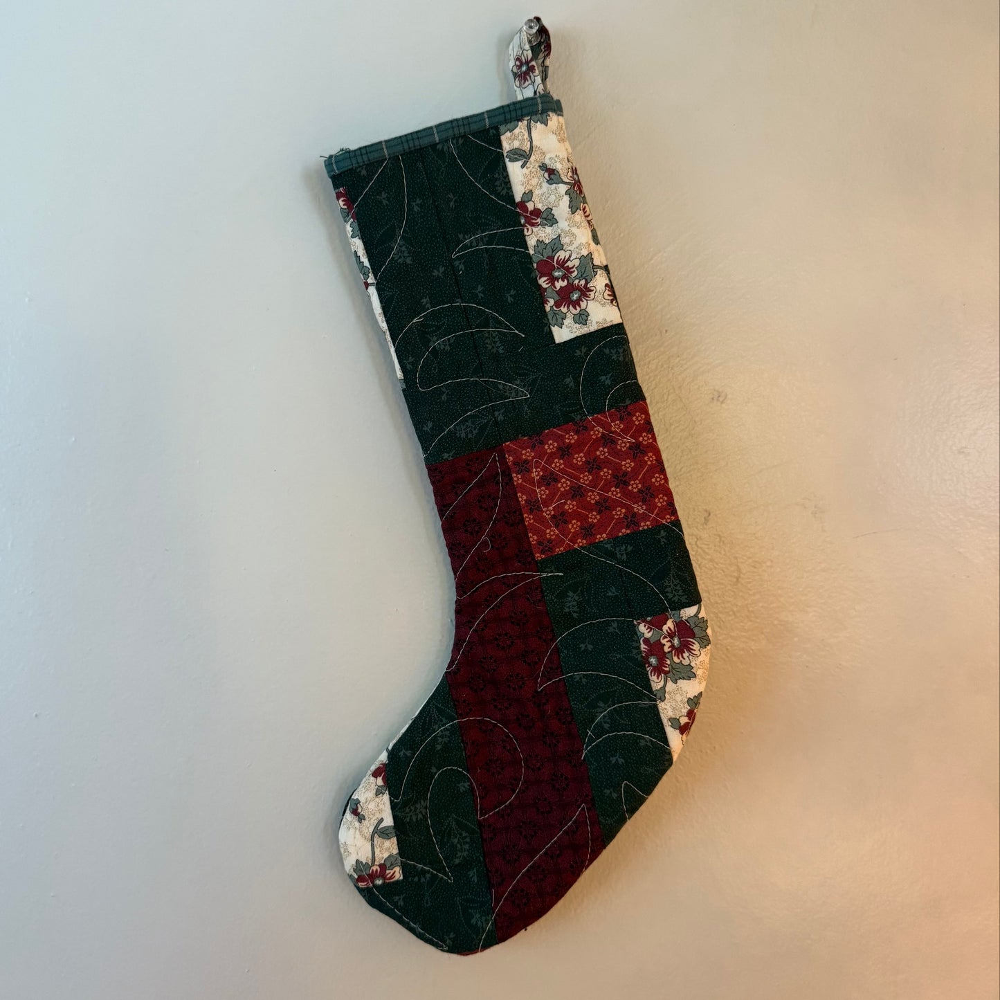 Patchwork Christmas child's stocking on a white background